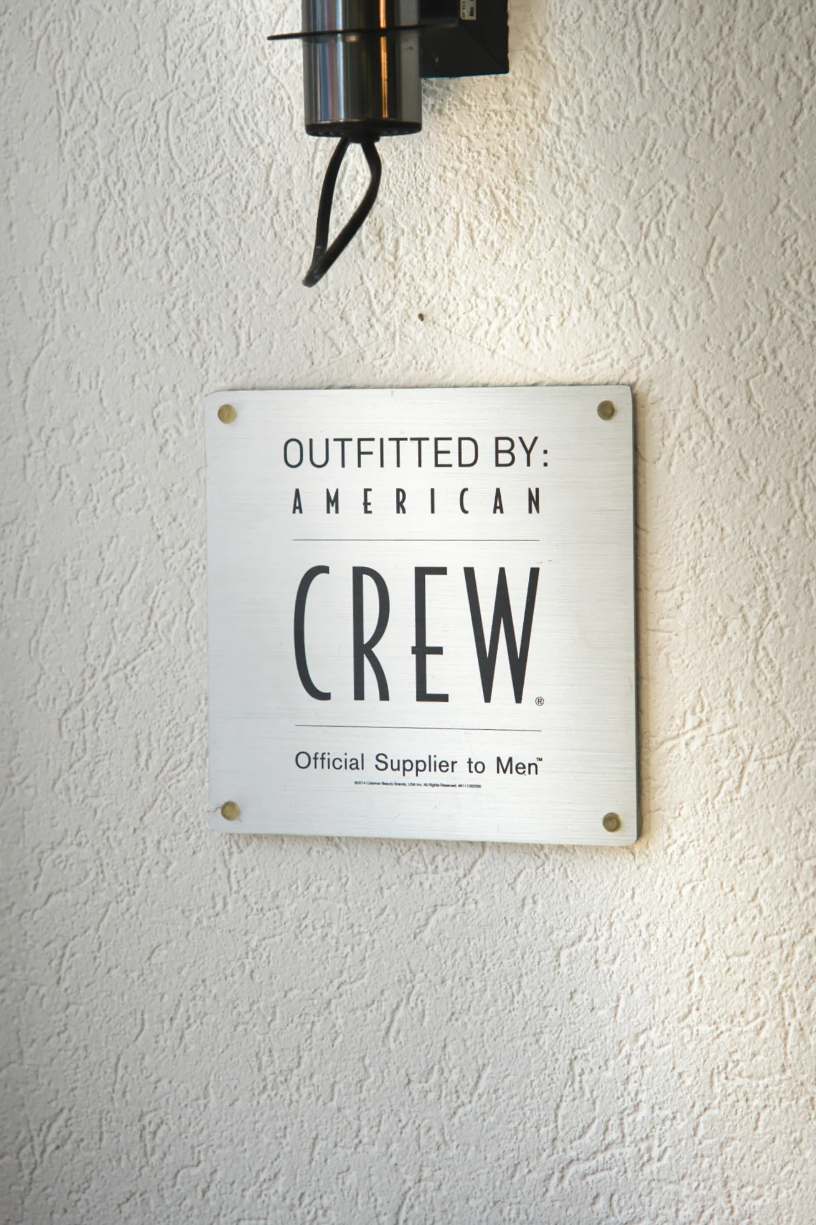 Plaque American Crew Mur — Figaro Coiffure Châtel-St-Denis